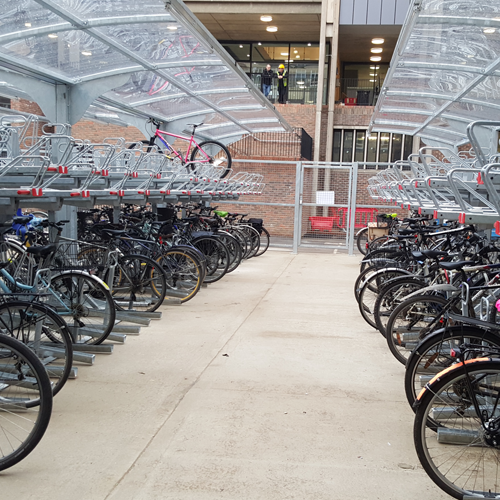 Rows of bicycle stored in undercover double-layer bike racks at Cambridge.