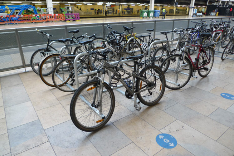 A line of Cyclehoop toast racks at Paddington Station in London with bicycles attached