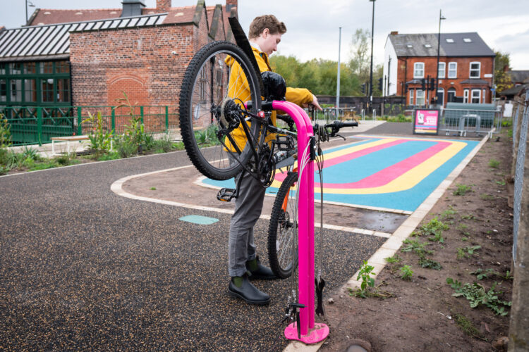 A pink Cyclehoop public repair stand in use