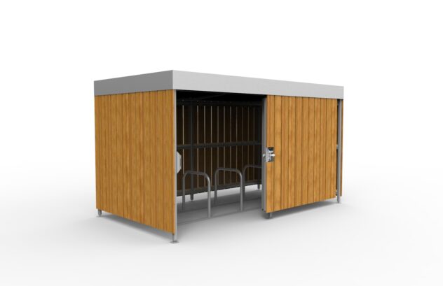 A rectangular Wood Bike Shelter with one sliding door pushed back to reveal metal bike stands inside.