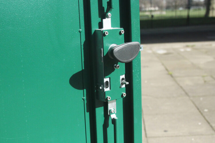A close-up of the metal handle and lock system of the green metal Vertical Bike Locker storage container.