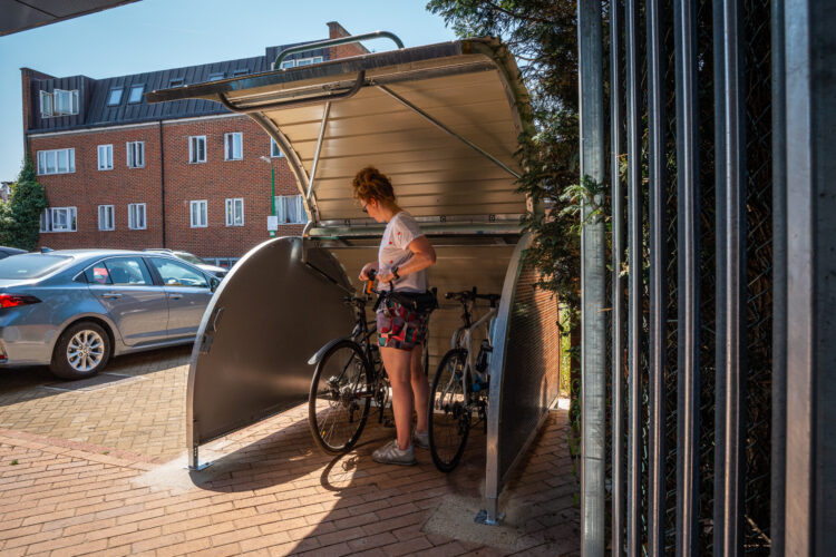 Woman locking bike in bikehangar