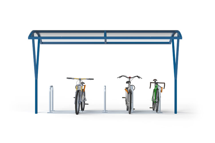 Three bikes parked against metal racks under a clear, curved canopy.