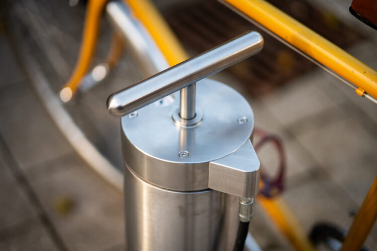 The handle of a metal bike pump.