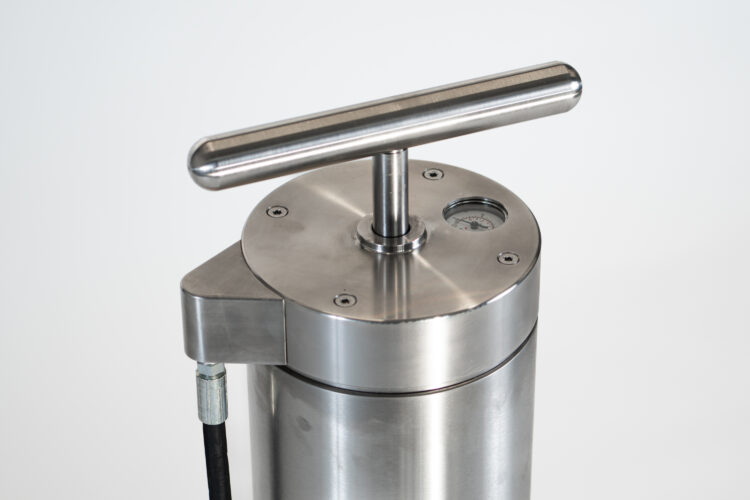 The handle of a metal bike pump.