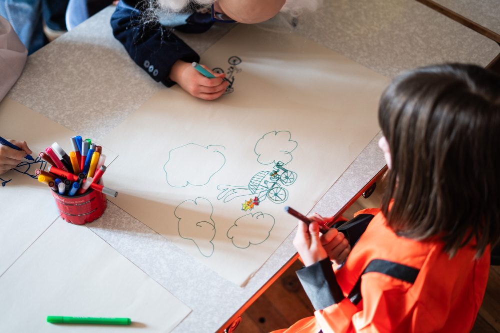 a child drawing a picture of a bicycle